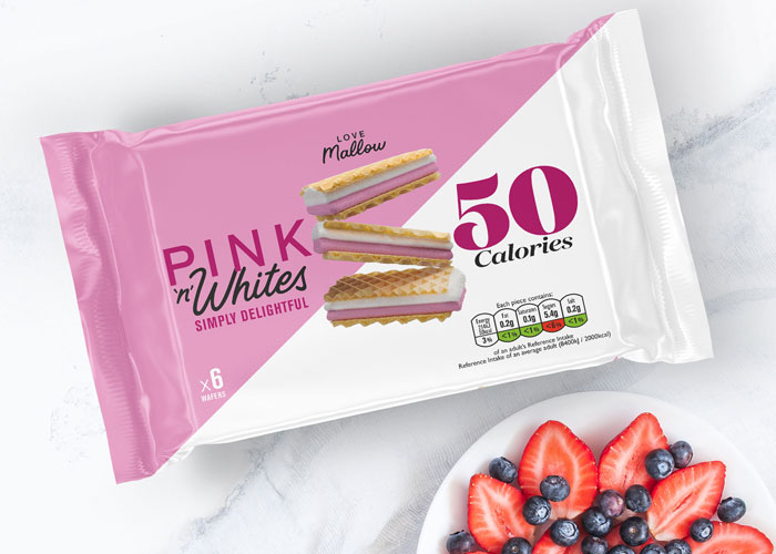 Pink & Whites packaging on a table next to a bowl of fruit