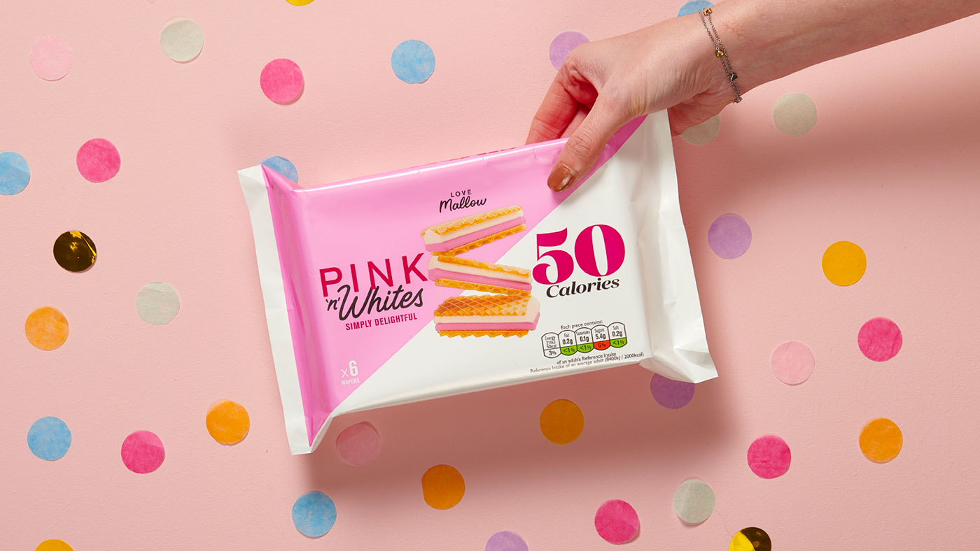 An image of a hand holding a pack of Pink & Whites