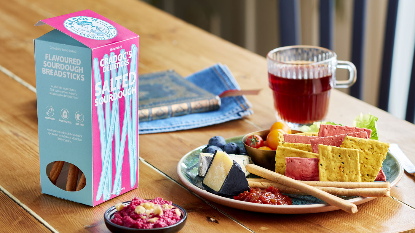 Image of Cradoc's packaging on table next to plate of food